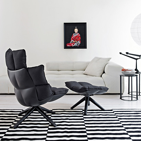 modern living room featuring b&b italia husk armchair and ottoman with wood base