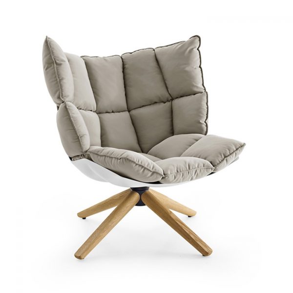 b&b italia husk armchair with wood base on a white background