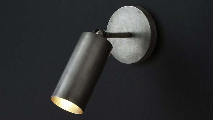 apparatus cylinder sconce on a black background
