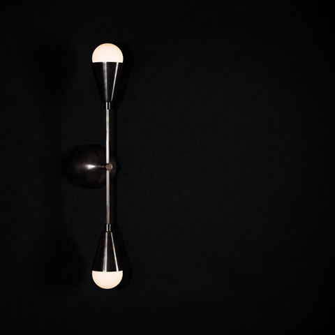 apparatus dyad sconce on a black background
