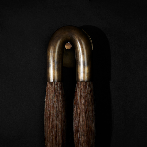 apparatus horsehair sconce on a black background
