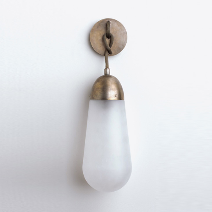 apparatus lariat sconce on a soft grey background