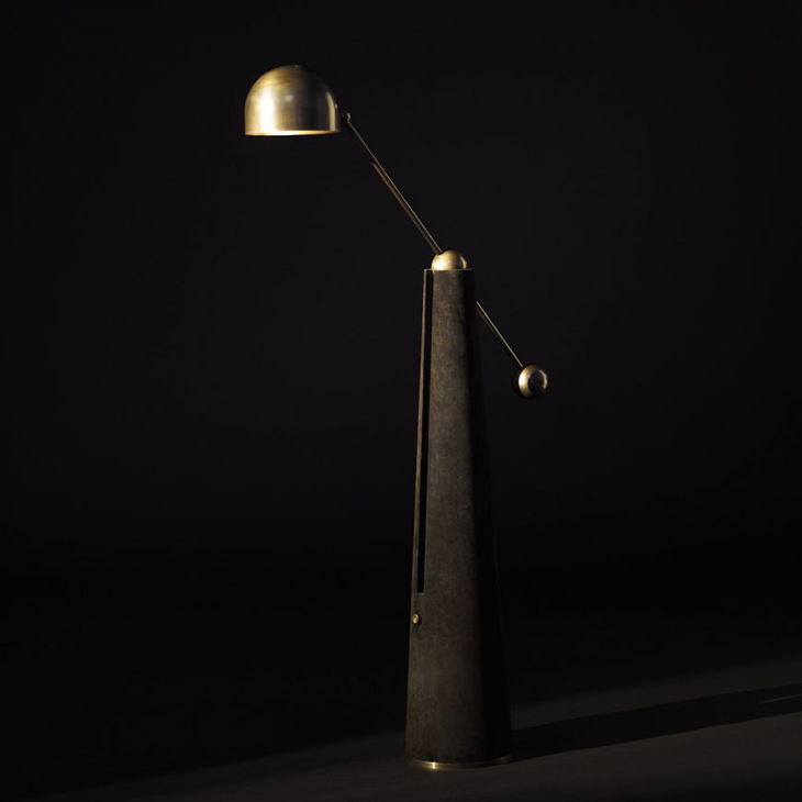apparatus metronome articulating floor lamp on a black background