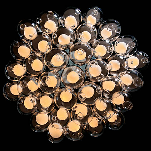 worm's eye view of bocci 28 series cluster pendant against a black background