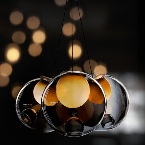 bocci 28.3 cluster pendant light glowing against a dark background