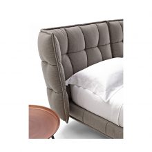 detail of b&b italia husk bed on white background