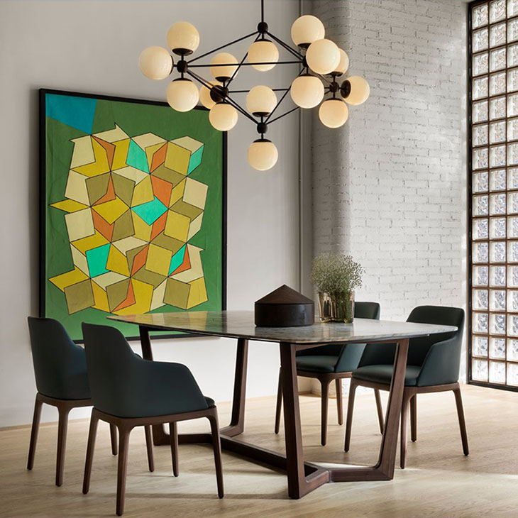 modern dining room featuring a roll and hill modo chandelier