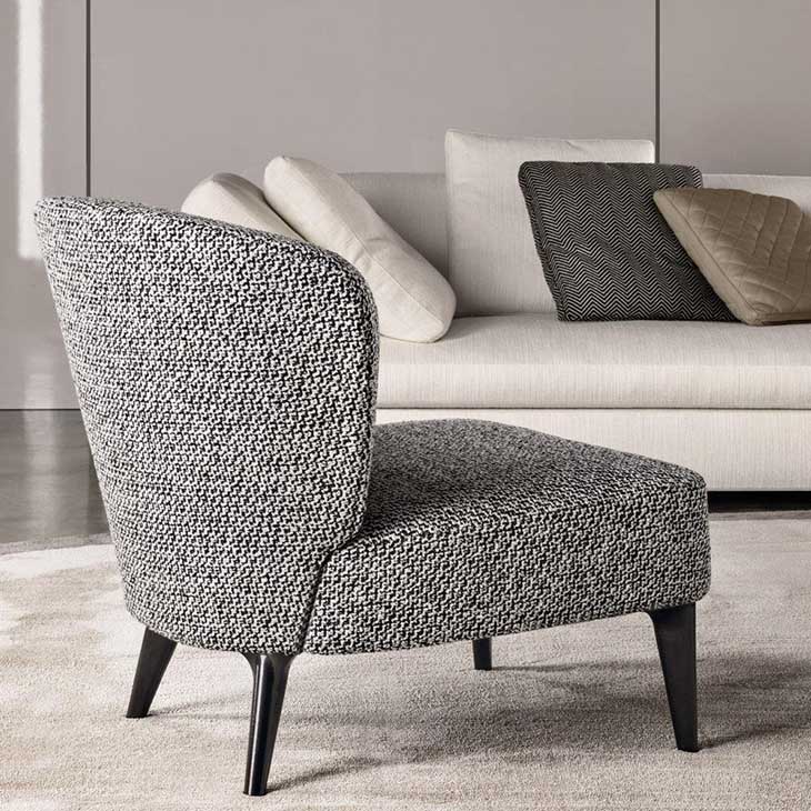 modern living room featuring minotti aston armchair without armrests