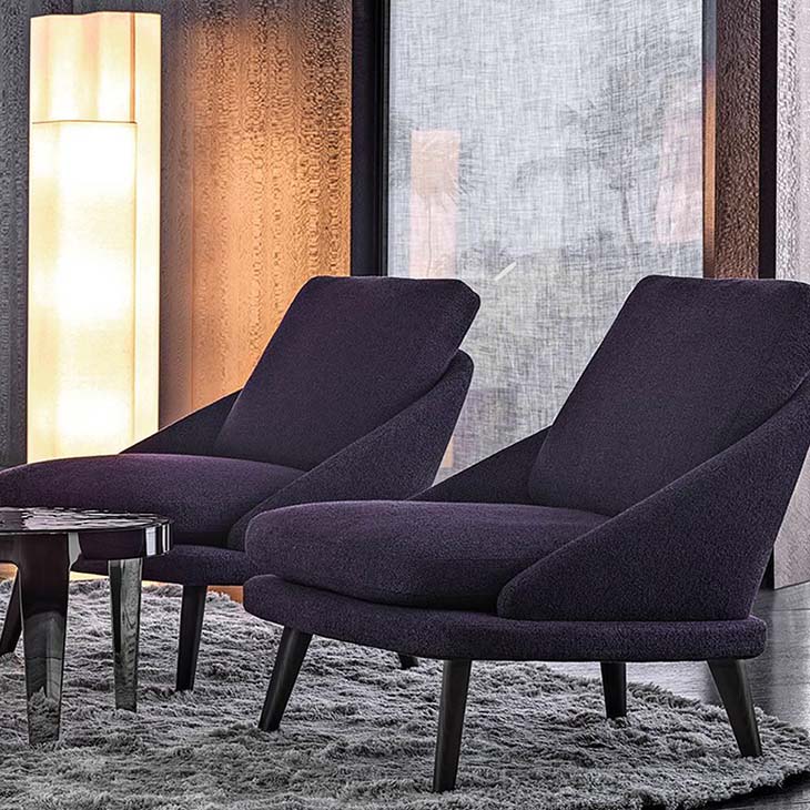 modern living room featuring two minotti lawson armchairs with wood legs