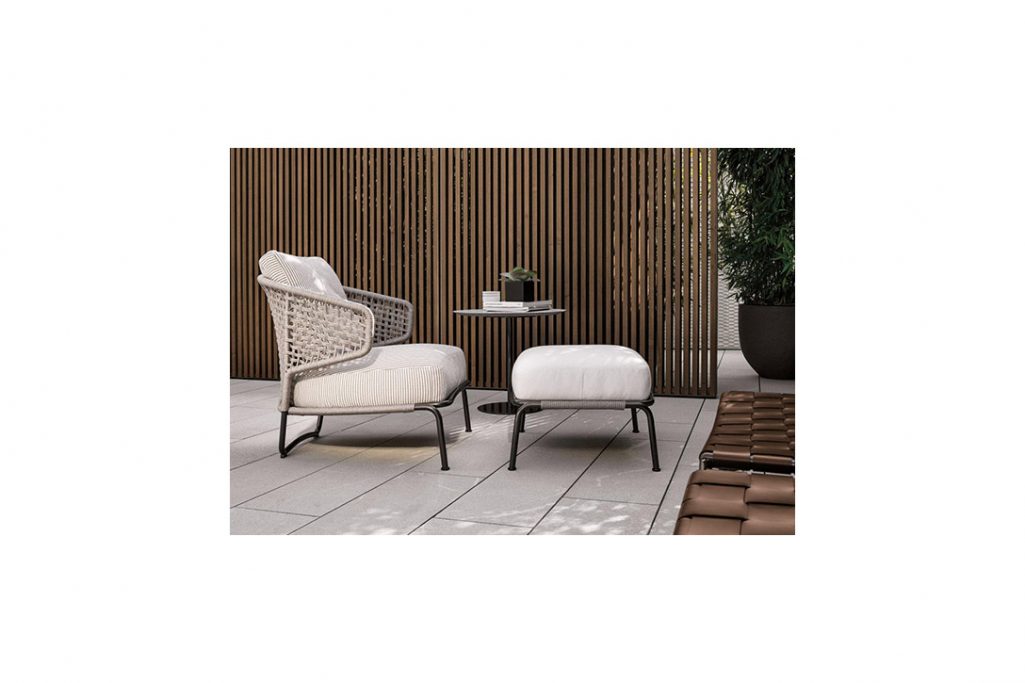 minotti aston cord outdoor armchair and ottoman in situ