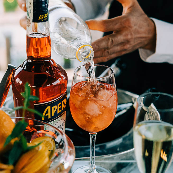bartender pouring an aperol spritz in milan