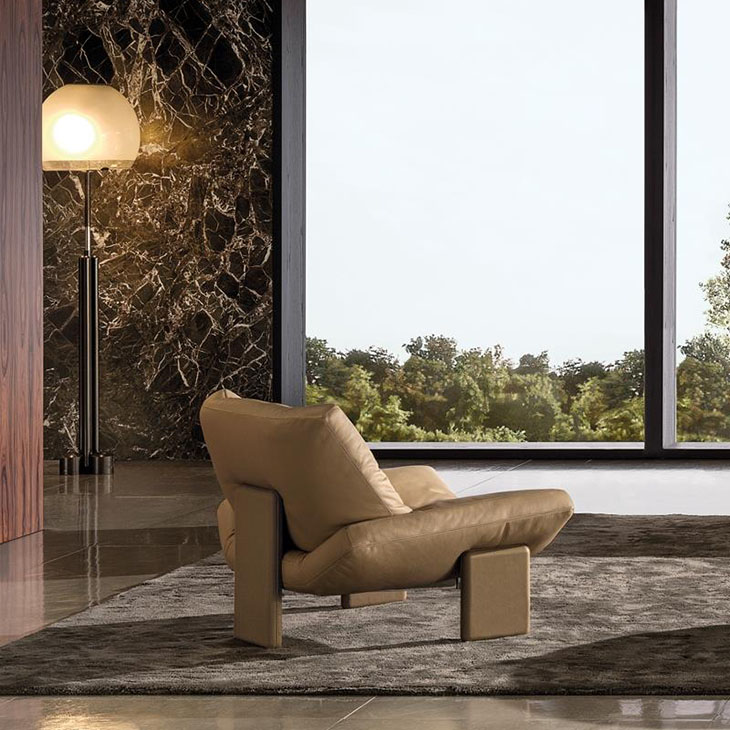 3/4 view of a minotti emmi armchair in situ